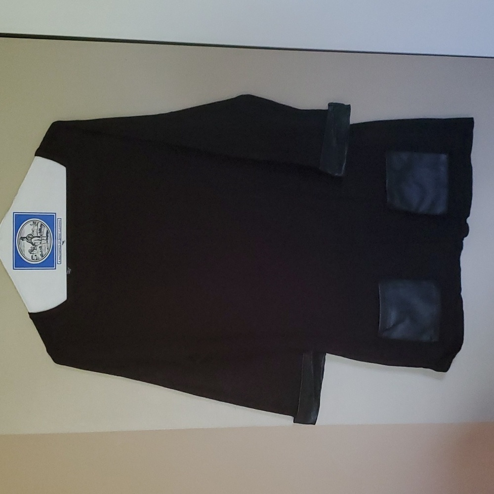 Black shirt with leather trim on sleeves and leather pockets. Lety&me size M
